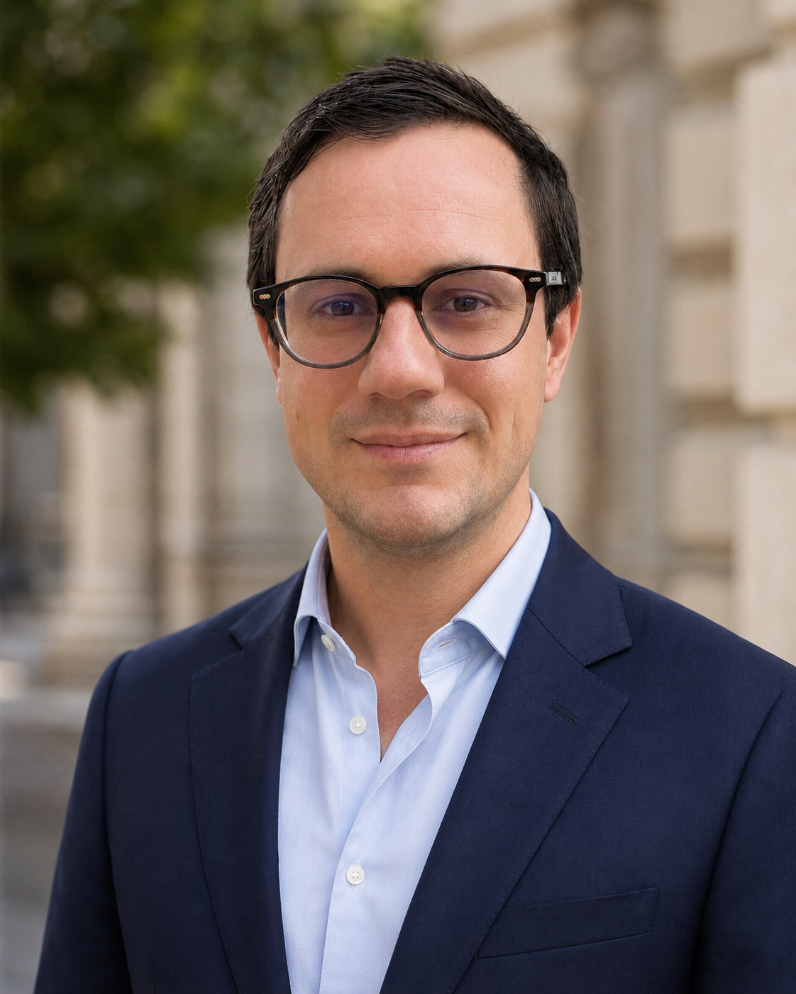Dr Michael Rowe outdoors in a navy jacket and light blue shirt