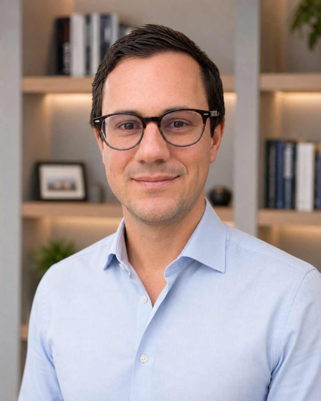 Dr Michael Rowe with glasses in a light blue shirt